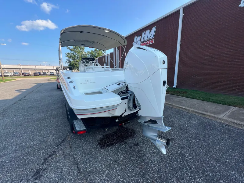Slide: The Image of 2020 Tahoe 2150 CC boat with outboard motor, parked near a brick building. - 7
