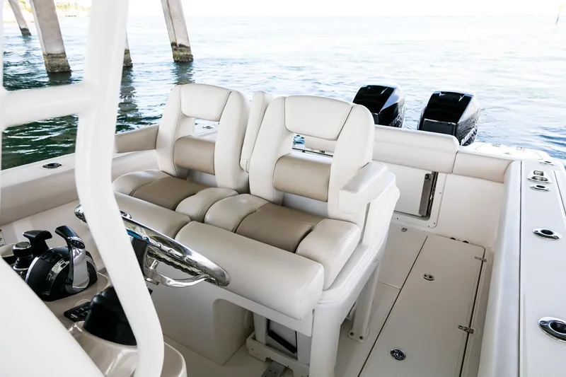 Slide: The Image of Manufacturer Provided Image: 2025 Boston Whaler 280 Outrage boat interior with dual seats and twin engines. - 23