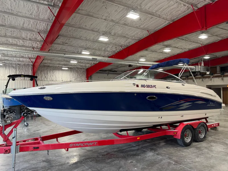 Slide: The Image of 2005 Chaparral 260 SSi boat on red trailer in indoor storage facility. - 1