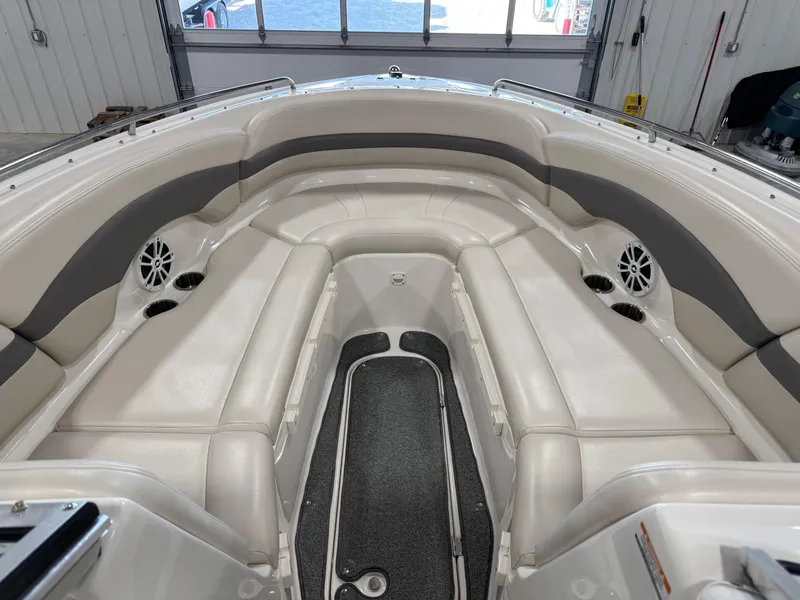 Slide: The Image of 2005 Chaparral 260 SSi boat interior with white leather seating and cup holders. - 10