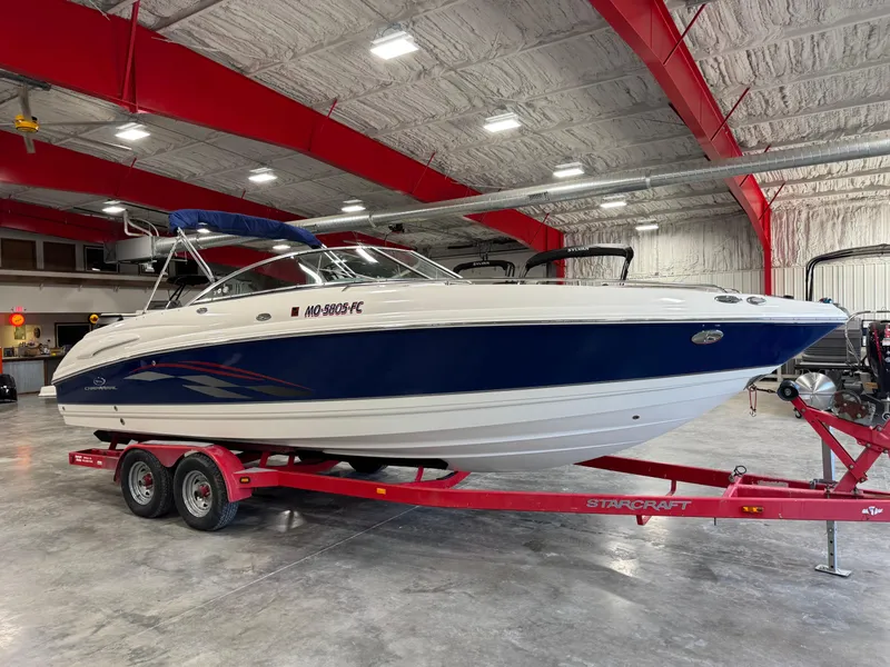 Slide: The Image of 2005 Chaparral 260 SSi boat on red trailer in indoor storage facility. - 2