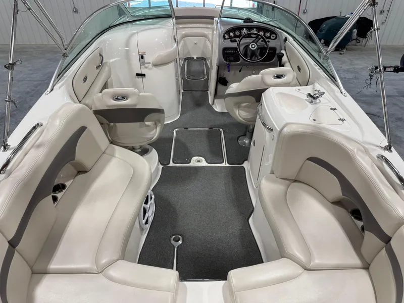 Slide: The Image of 2005 Chaparral 260 SSi boat interior with white seating and modern dashboard. - 6