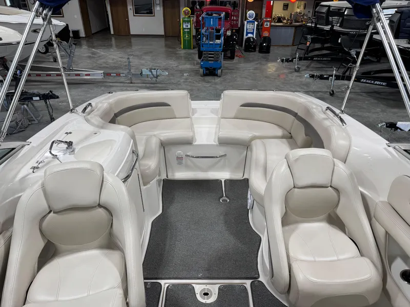 Slide: The Image of 2005 Chaparral 260 SSi boat interior with white seating and gray carpet. - 7