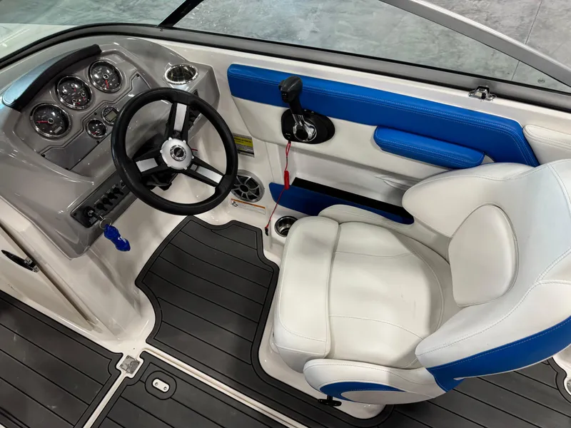 Slide: The Image of 2018 Chaparral 21 H2O boat interior with steering wheel and dashboard controls. - 10