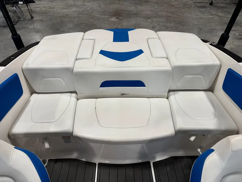 Slide: The Image of White and blue seating on 2018 Chaparral 21 H2O boat, indoor setting. - 11