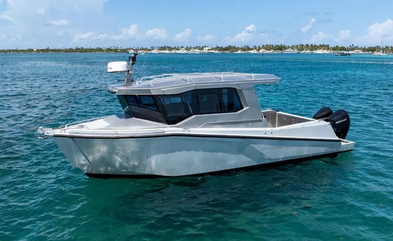 Slide: The Image of Novielli Alaskan 296 boat, 2026 model, cruising on clear blue water. - 2