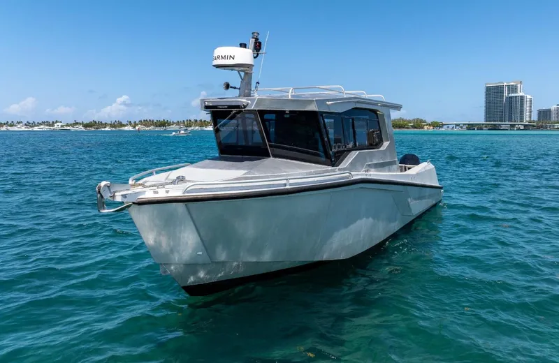 Slide: The Image of 2026 Novielli Alaskan 296 boat on clear blue water near city skyline. - 3