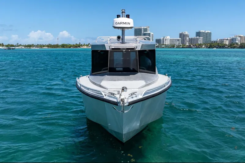 Slide: The Image of 2026 Novielli Alaskan 296 boat on clear blue water with city skyline background. - 4
