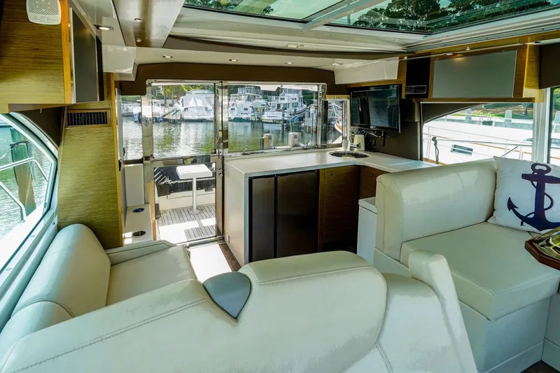 Slide: The Image of Luxurious interior of 2016 Cruisers Yachts 45 Cantius with modern seating and marina view. - 12