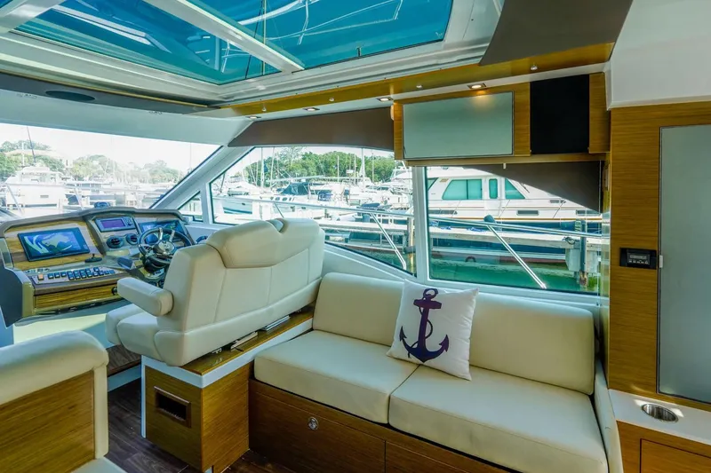 Slide: The Image of Interior of 2016 Cruisers Yachts 45 Cantius with helm and seating area. - 14