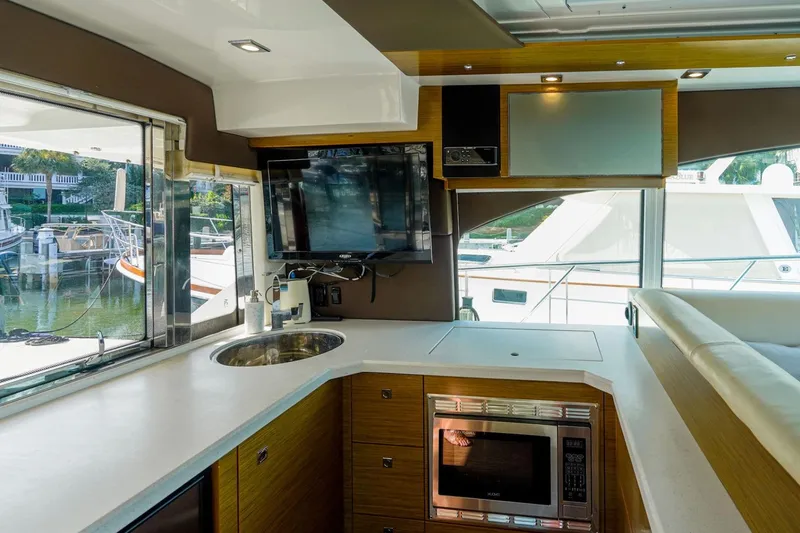 Slide: The Image of Luxurious interior of 2016 Cruisers Yachts 45 Cantius with modern kitchen and scenic marina view. - 15