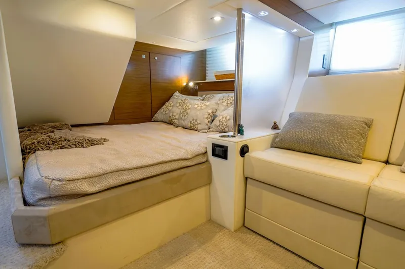 Slide: The Image of Luxurious 2016 Cruisers Yachts 45 Cantius cabin interior with cozy bed and seating area. - 17