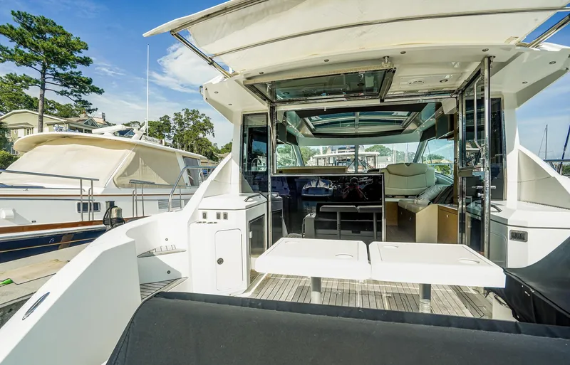 Slide: The Image of 2016 Cruisers Yachts 45 Cantius luxury yacht interior with open deck and seating area. - 2