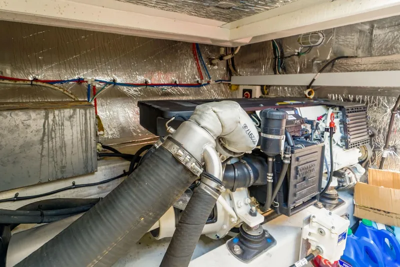 Slide: The Image of Engine room of 2016 Cruisers Yachts 45 Cantius with visible machinery and hoses. - 25