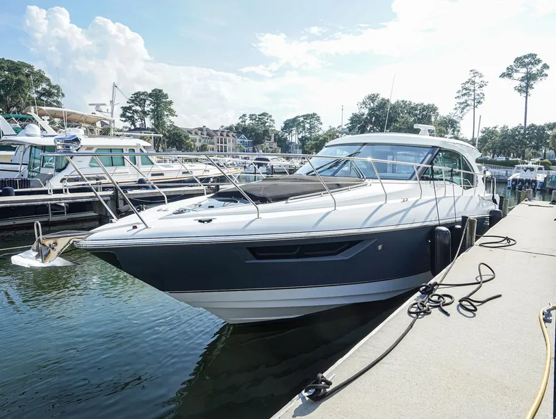 Slide: The Image of 2016 Cruisers Yachts 45 Cantius docked at marina, sunny day, surrounded by other boats. - 3