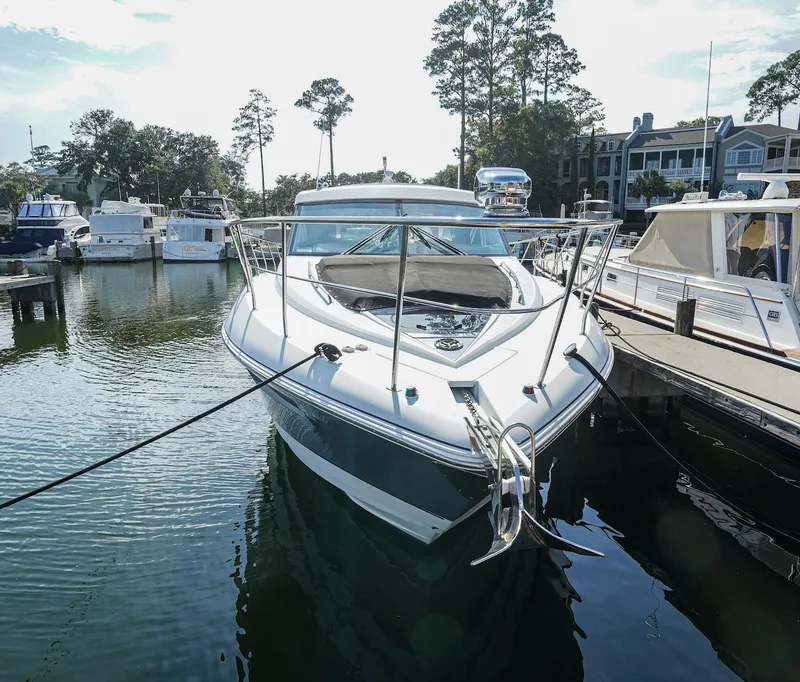 Slide: The Image of 2016 Cruisers Yachts 45 Cantius docked at marina, surrounded by other boats. - 4