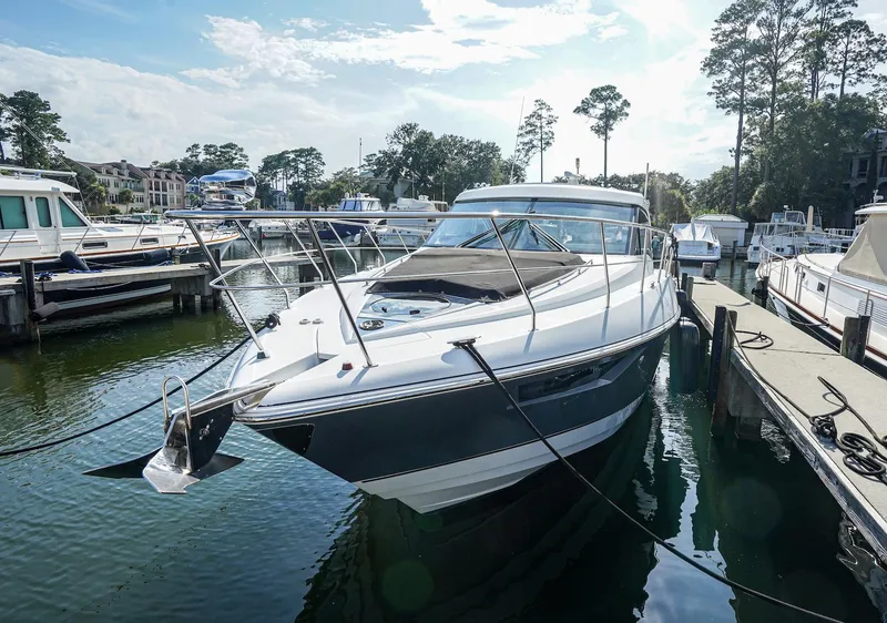 Slide: The Image of 2016 Cruisers Yachts 45 Cantius docked at marina, surrounded by other boats. - 5