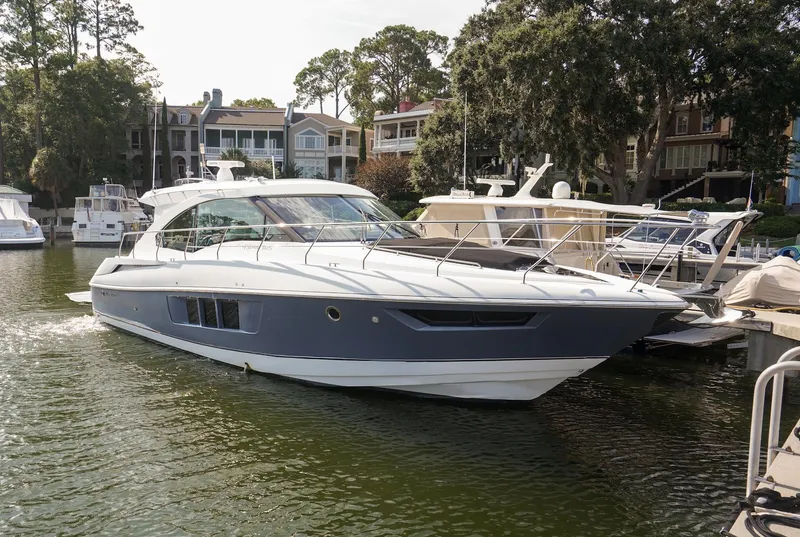 Slide: The Image of 2016 Cruisers Yachts 45 Cantius docked in a scenic marina setting. - 6