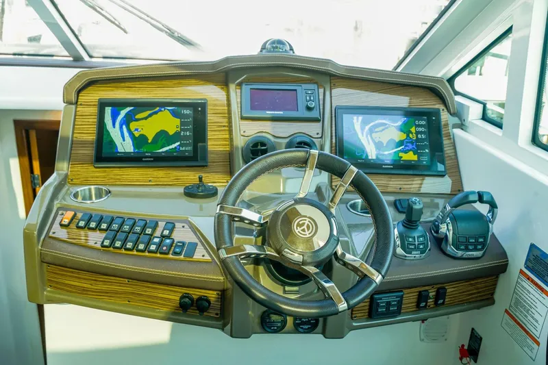 Slide: The Image of Helm of 2016 Cruisers Yachts 45 Cantius with navigation screens and controls. - 7