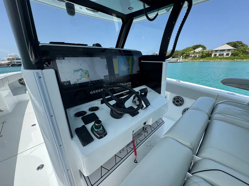 Slide: The Image of Modern Freeman 38 boat cockpit with advanced navigation system, steering wheel, and luxurious seating, 2025 model. - 11