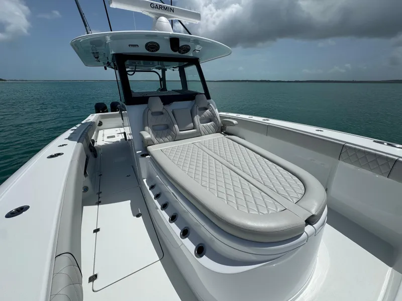 Slide: The Image of 2025 Freeman 38 boat with luxurious seating on calm waters under cloudy sky. - 19