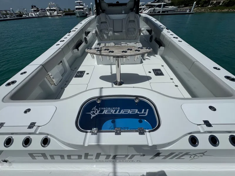 Slide: The Image of 2025 Freeman 38 boat interior with seating and fishing setup, docked in a marina. - 25