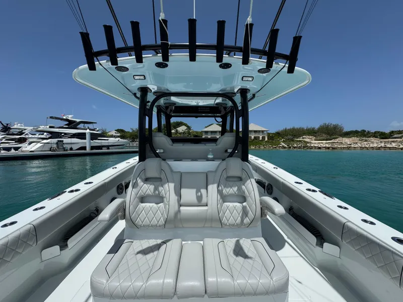 Slide: The Image of Luxurious 2025 Freeman 38 boat interior with plush seating, docked near yachts. - 27