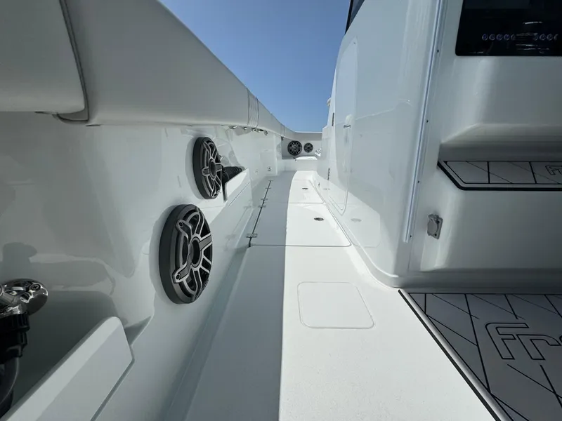 Slide: The Image of Sleek interior of a 2025 Freeman 38 boat, featuring modern design and audio speakers. - 37