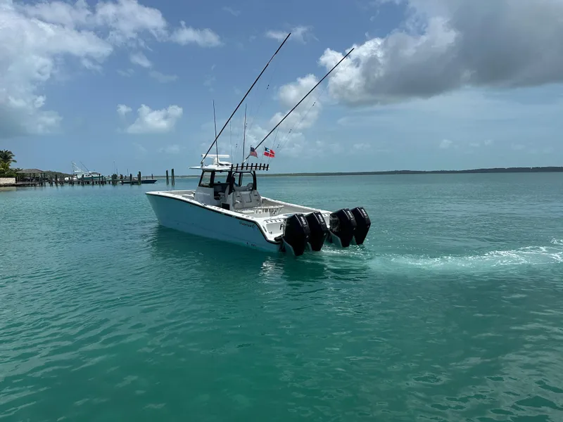 Slide: The Image of A 2025 Freeman 38 boat cruising on clear turquoise waters under a partly cloudy sky. - 5