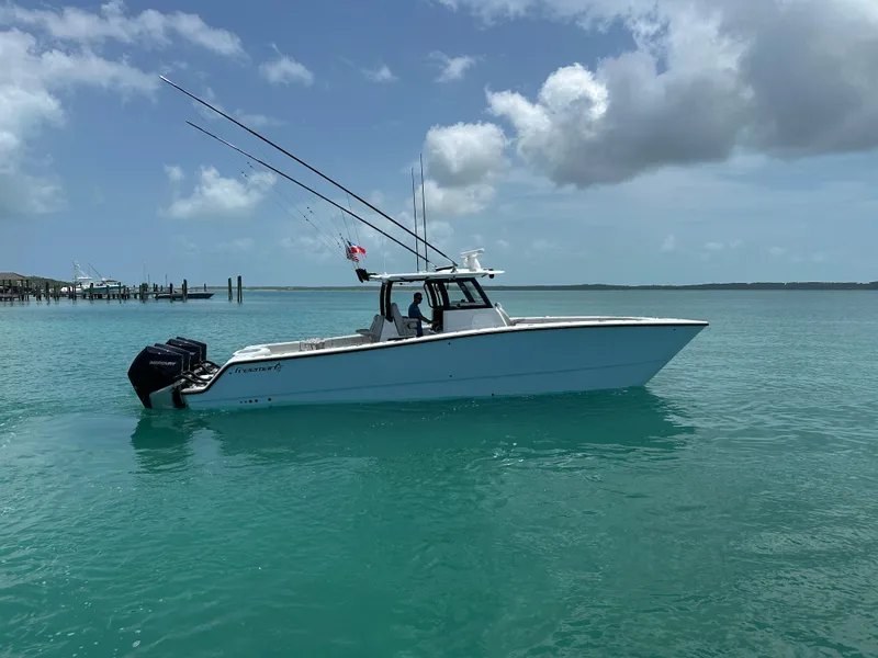 Slide: The Image of 2025 Freeman 38 boat on turquoise water under a partly cloudy sky. - 8