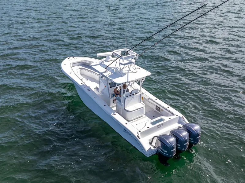Slide: The Image of 2021 Yellowfin 34 boat with triple Yamaha engines on open water. - 10