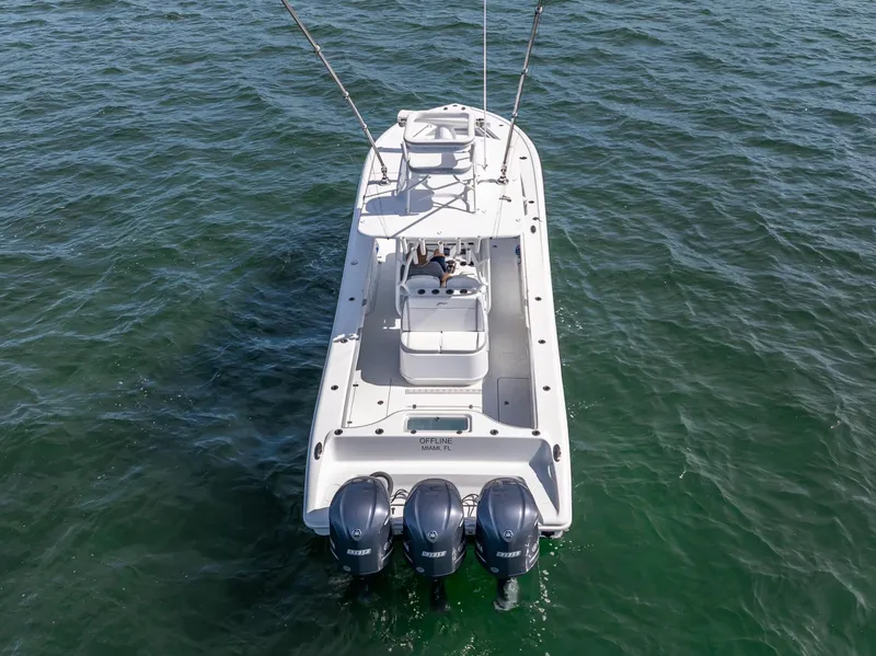Slide: The Image of 2021 Yellowfin 34 boat with triple outboard engines on open water. - 11