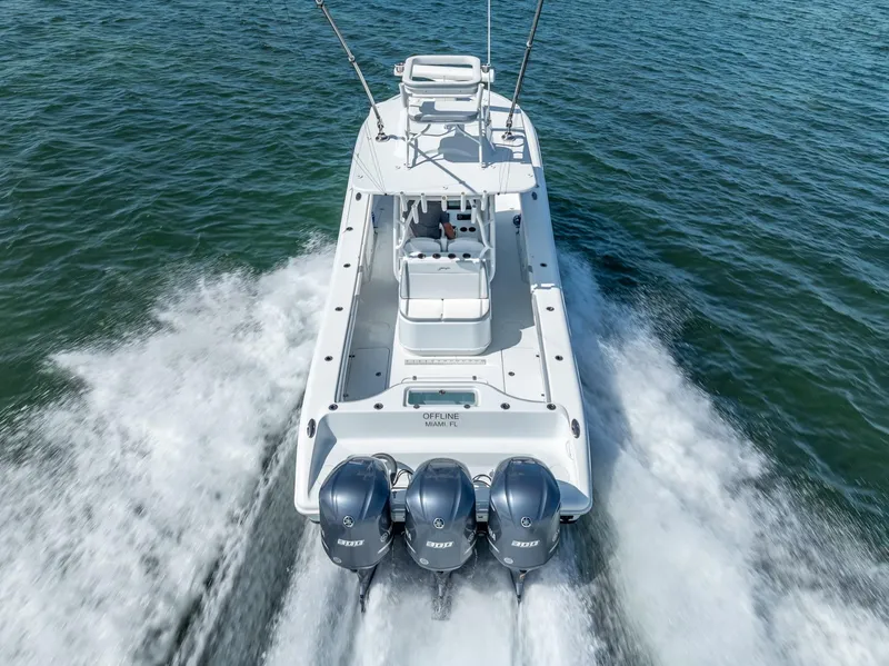 Slide: The Image of 2021 Yellowfin 34 boat cruising on water with triple outboard engines. - 15