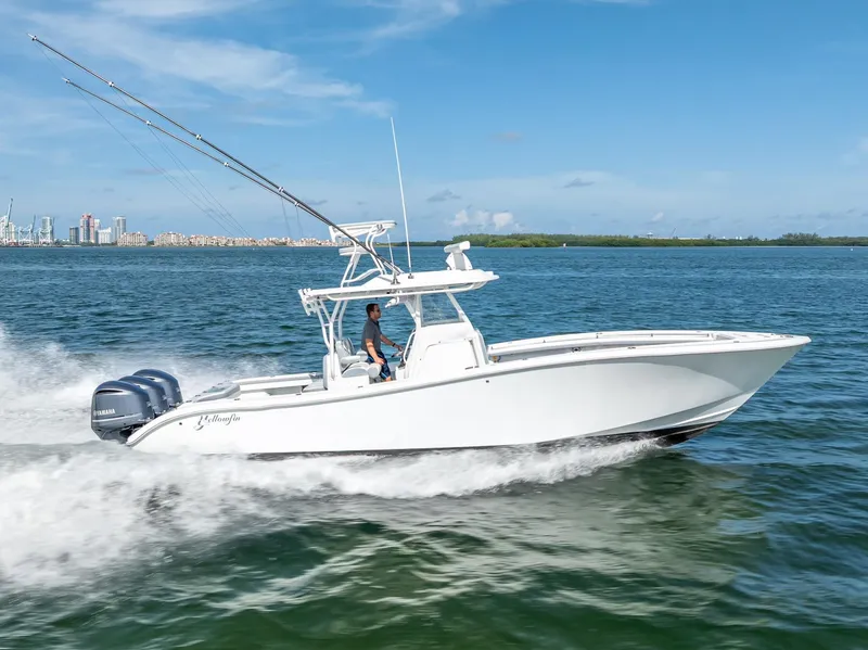 Slide: The Image of 2021 Yellowfin 34 boat cruising on open water under clear blue sky. - 19
