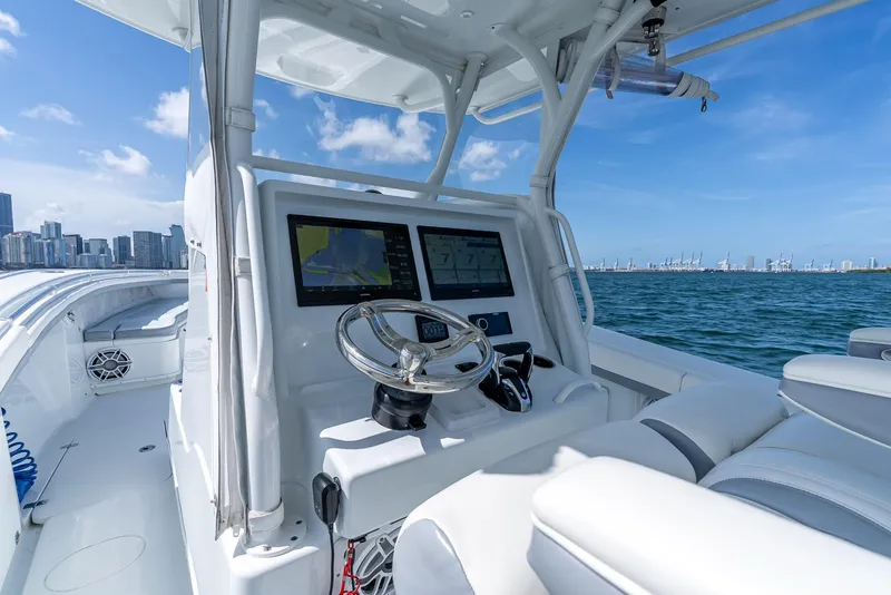 Slide: The Image of 2021 Yellowfin 34 boat dashboard with city skyline and ocean view. - 21