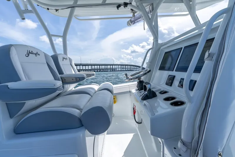 Slide: The Image of 2021 Yellowfin 34 boat interior with helm, seats, and ocean view. - 23