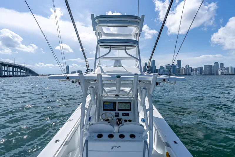 Slide: The Image of 2021 Yellowfin 34 boat navigating near city skyline and bridge on a sunny day. - 24