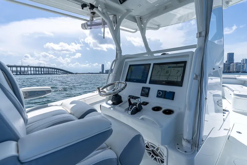 Slide: The Image of 2021 Yellowfin 34 boat dashboard with modern controls and ocean view. - 27