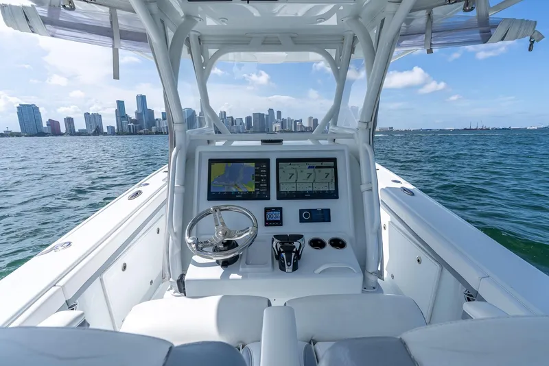 Slide: The Image of 2021 Yellowfin 34 boat dashboard with city skyline in the background. - 28