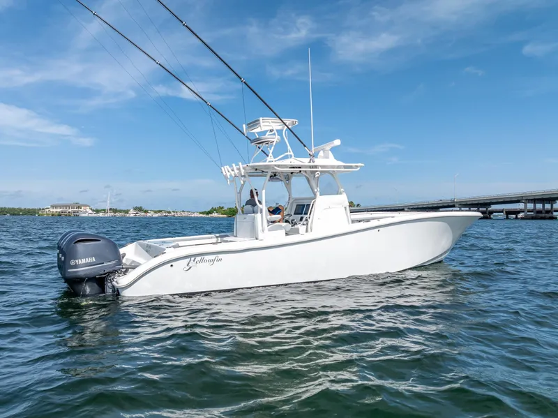 Slide: The Image of 2021 Yellowfin 34 boat on water with Yamaha engine, clear sky background. - 3