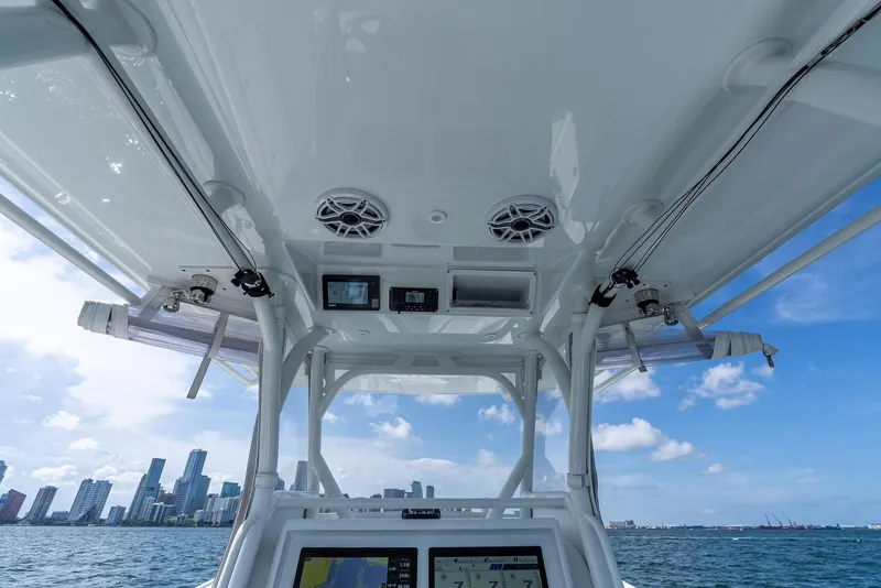 Slide: The Image of 2021 Yellowfin 34 boat interior with city skyline, featuring navigation equipment and speakers. - 30