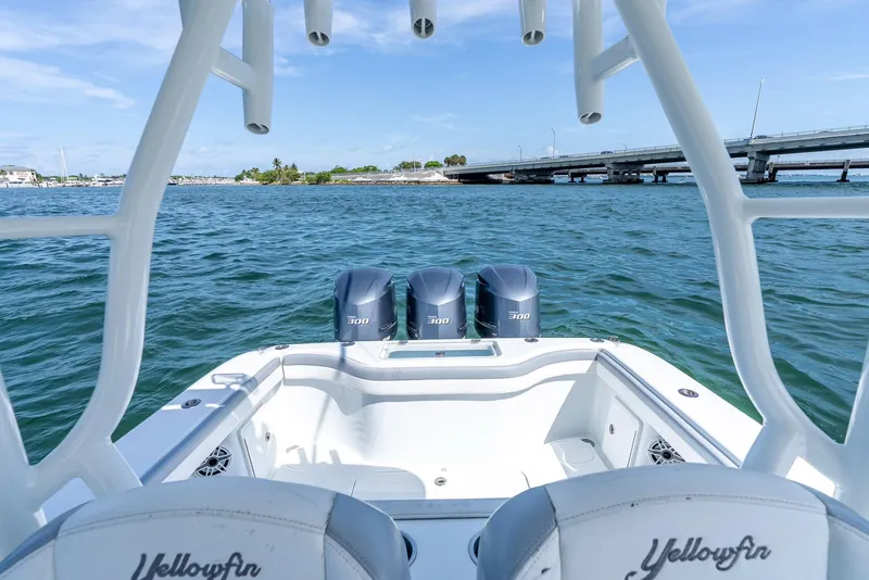 Slide: The Image of 2021 Yellowfin 34 boat with triple 300 horsepower engines on open water. - 33