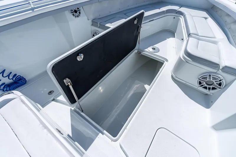 Slide: The Image of 2021 Yellowfin 34 boat interior with open storage compartment and seating area. - 36