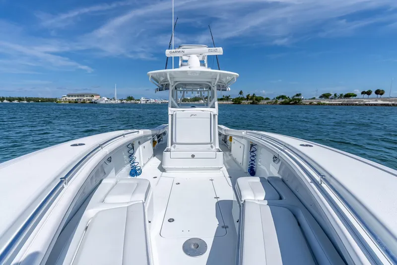 Slide: The Image of 2021 Yellowfin 34 boat on water, clear sky, spacious deck, Garmin equipment. - 37
