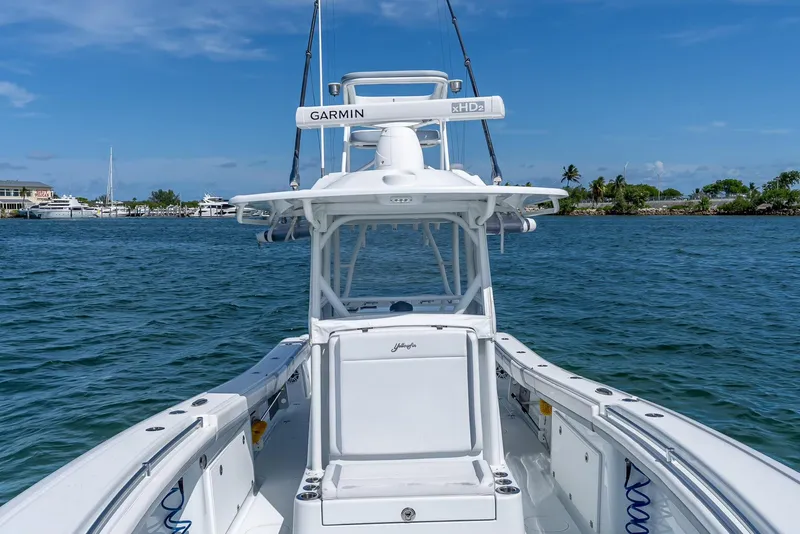 Slide: The Image of 2021 Yellowfin 34 boat on water, featuring Garmin equipment, under clear blue sky. - 38