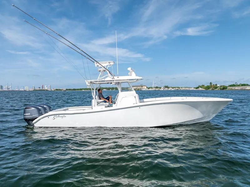 Slide: The Image of 2021 Yellowfin 34 boat cruising on open water under a clear blue sky. - 4