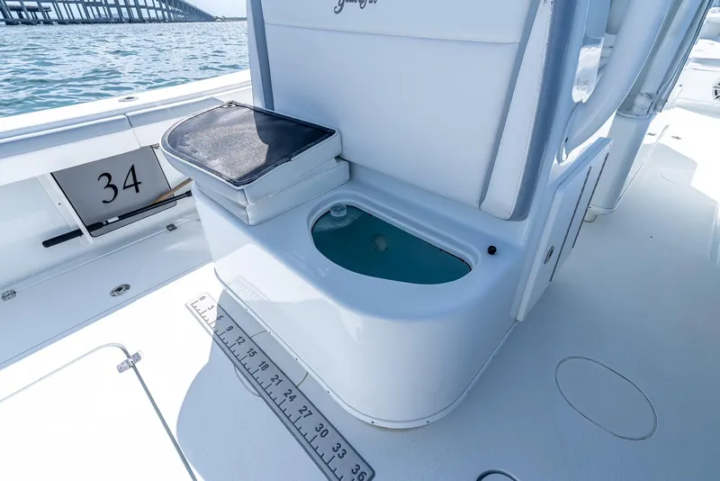 Slide: The Image of 2021 Yellowfin 34 boat interior with livewell and measuring ruler on deck. - 44