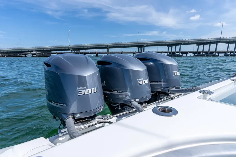 Slide: The Image of Triple Yamaha 300 engines on a 2021 Yellowfin 34 boat near a bridge. - 45