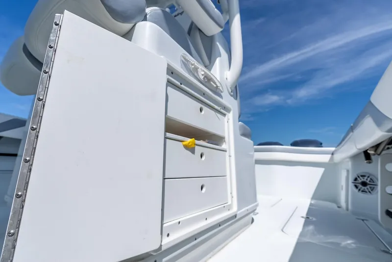Slide: The Image of 2021 Yellowfin 34 boat interior with storage drawers under a clear blue sky. - 49