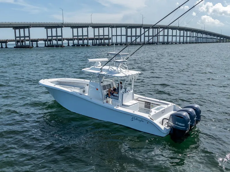 Slide: The Image of 2021 Yellowfin 34 boat on water near a bridge, equipped with Yamaha engines. - 9